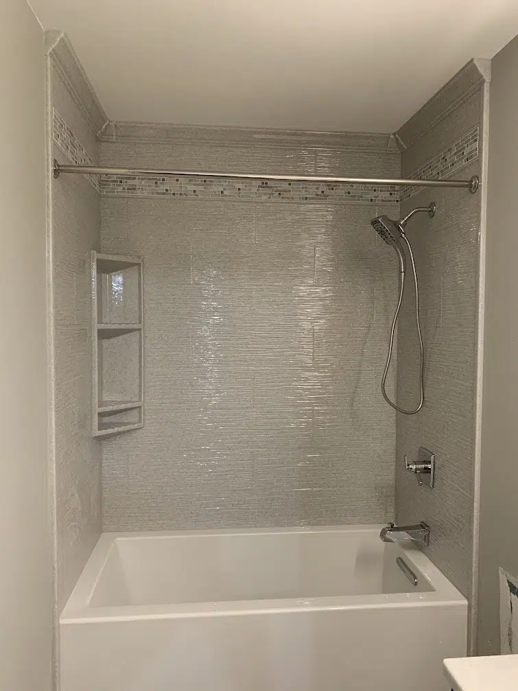 Tub surround renovation with Onyx wall panels and upgraded fixtures